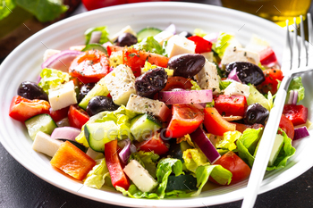 Greek salad with olives at black.