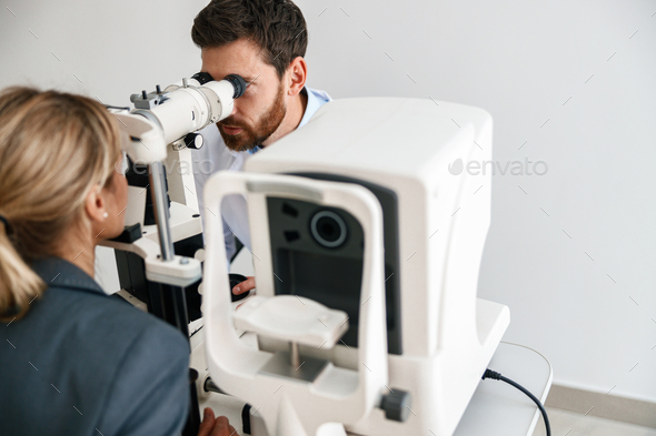 Ophthalmologist checks a patient\'s vision at an opticians shop or ophthalmology clinic. Close up