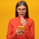 Shocked woman reading message with petrifying news on phone touching opened mouth - PhotoDune Item for Sale