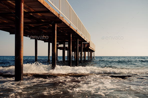 Pier vanishes to horizon in the sea - Stock Photo - Images