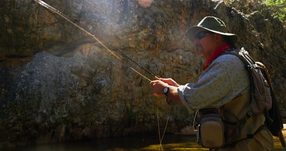 Fisherman fly fishing in river alt