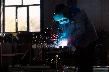Industrial welder welding metal profiles