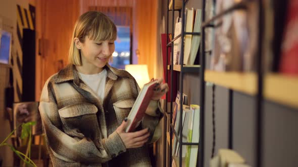 Woman Reading Book in Library alt