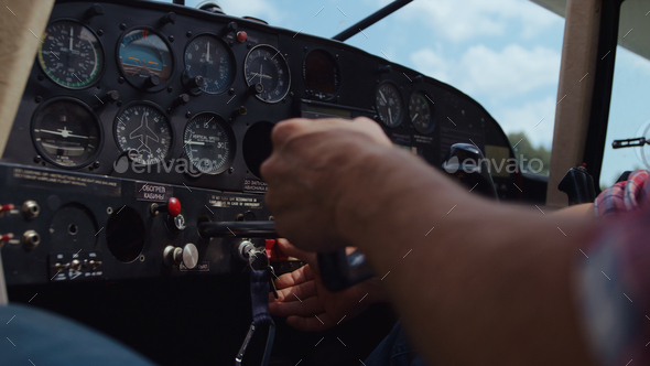 Aviator hands ready piloting airplane in technological aircraft cabin closeup.
