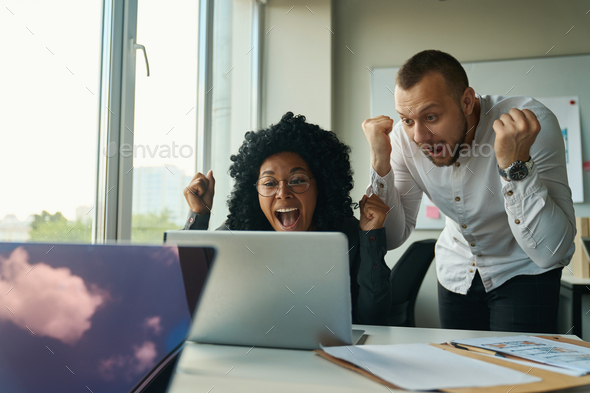 Managers at the computer rejoice at the promotion