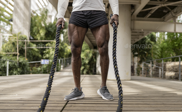 Close up of legs of sporty african man training, man with bodybuilder musculature - Stock Photo - Images