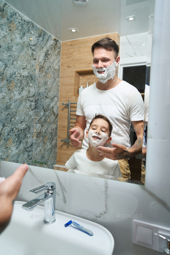 Dad and son have a fun shave