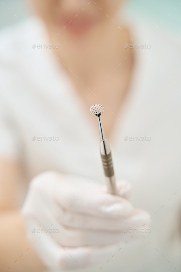 Female doctor is showing uno spoon close up - Stock Photo - Images
