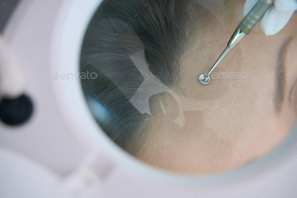 Cleaning face with uno spoon close up - Stock Photo - Images