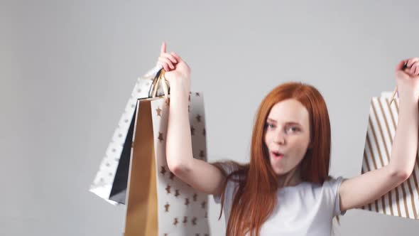 Portrait of Young Happy Smiling Girl with Shopping Bags. Slow Motion