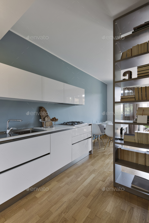 internal view of a modern white lacquered kitchen with wooden floor