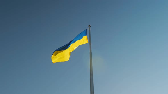 The Flag of Ukraine a Silk Flag Flies Against the Background of the Night Sky on a Large Flagpole
