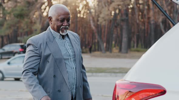 Mature African American Businessman Shopper Walking Down Street Coming Back From Store Carrying Gift alt