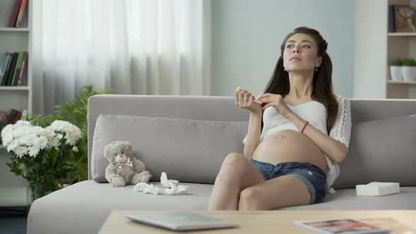 Future Mother Using Tissues to Blow Stuffy Nose, Feeling Her Forehead, Cold alt