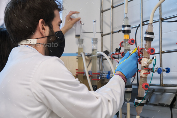 Two researchers working with Fluidized Bed Reactors in a laboratory.