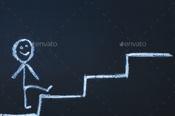 drawn man on the chalk board climbs up step by step to the top of career stairs. copy space
