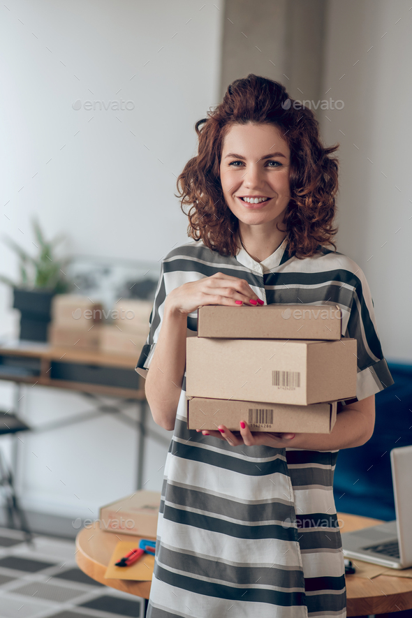 Online store employee posing for the camera at work - Stock Photo - Images