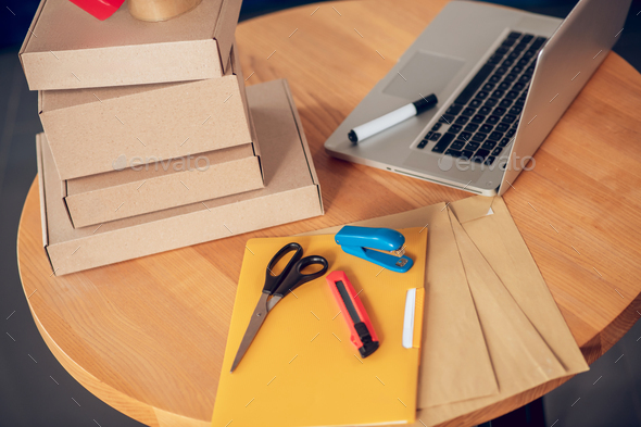 Set of packaging materials and a portable computer on the table - Stock Photo - Images