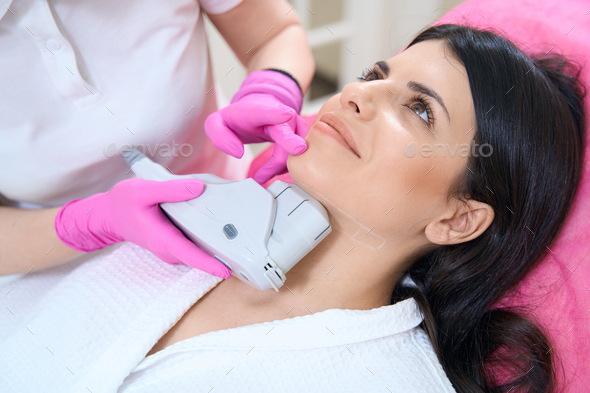 Doctor performs procedure for tightening skin with an ultrasonic lifting device
