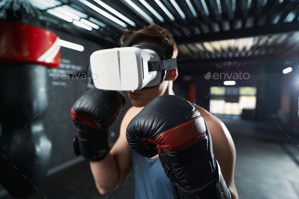 Professional sportsperson doing boxing workout in virtual reality - Stock Photo - Images