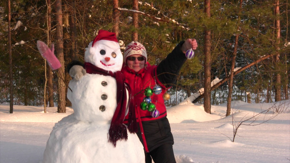 Woman Poses With Snowman
