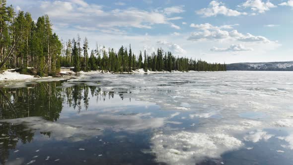 Beautiful Winter Natural Landscape Drone Flying Over Melting Lake with Clouds alt