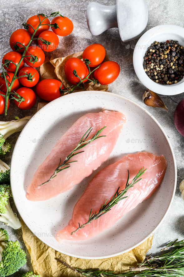 Turkey fillet. Farm poultry breast meat. Gray background. Top view