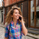 Close up happy woman walking in city talking with mobile phone - PhotoDune Item for Sale