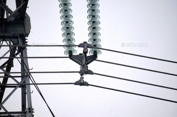 High voltage tower with electric power lines divided by safe guard