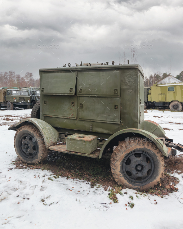 Mobile army diesel power generator abandoned along with military equipment in the snow.