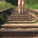 Closeup of a person walking on the railway on a sunny day - new opportunities - PhotoDune Item for Sale