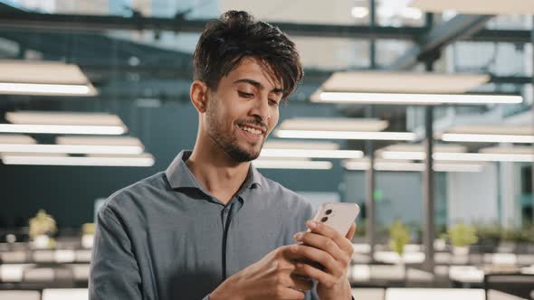 Smiling Arabian Male Professional Manager Entrepreneur Supervisor Business Man Holding Smartphone alt