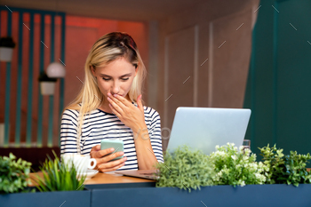 Portrait of a woman working on laptop in cafe. People business education digital device concept.