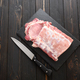 A large piece of pork loin on a rustic dark background. - PhotoDune Item for Sale