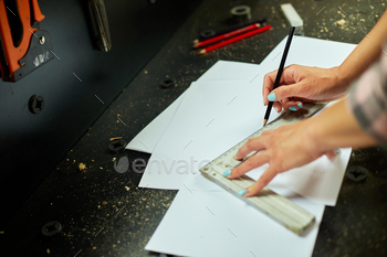 Female interior designer working on drawings, woman architect draws