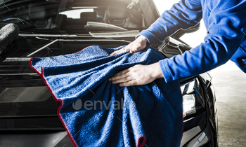 Car Detailer Cleaning Vehicle Body Using Soft Cloth