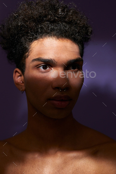 Close-up confident young man in natural light. Verticale portrait of muscular transgender male