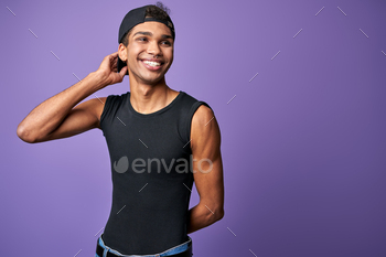 Happy young transgender man smile portrait. Cheerful latino male in black t-shirt. Purple