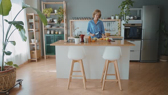 beautiful senior woman spending time in her cozy apartment alt