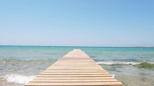 Slow-motion Video of Wooden Pier Against the Backdrop of Turquoise Sea alt