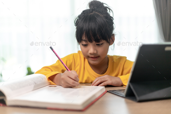 Asian little girl taking class on line and happy for Homeschool Quarantine