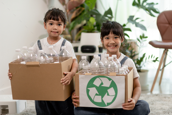 Smiling children having fun while segregating plastic bottles and paper ...