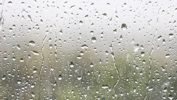 raindrops and trickles of rain on window glass Stock Photo by vvoennyy
