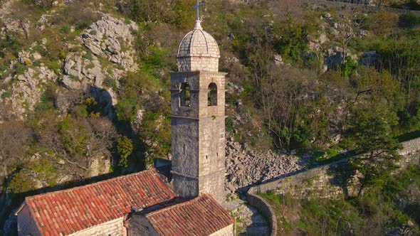 Aerial Shot of the Christian Church on a Way to the Top of the Mountain Where St alt