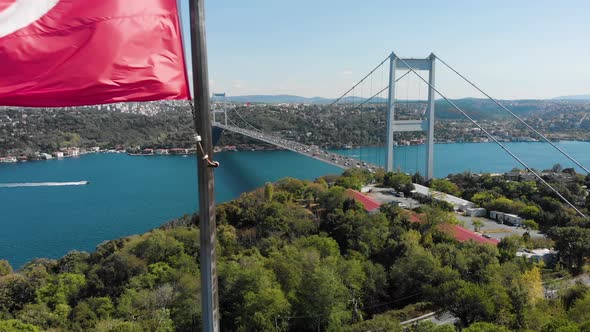 Aerial view of Fatih Sultan Mehmet Bridge and Turkish Flag alt