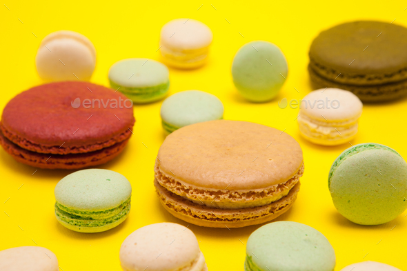 Luxury french macaroons dessert over yellow background