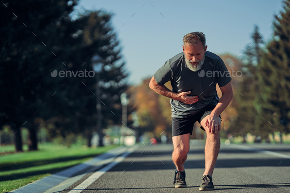 The old runner feeling bad while jogging.