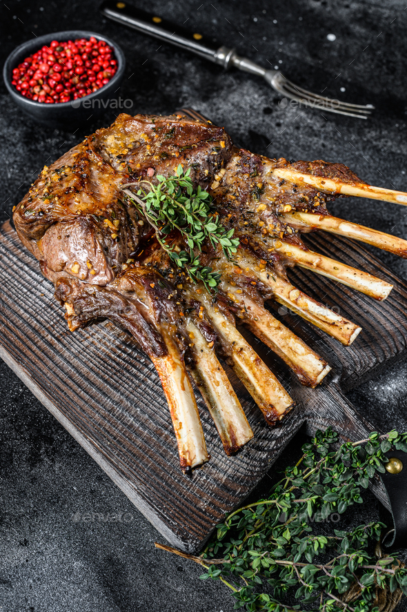 Barbecue rack of lamb meat chops. Black background. Top view Stock
