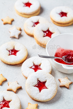 Christmas strawberry linzer cookies on gray background. Festive dessert, winter treat.