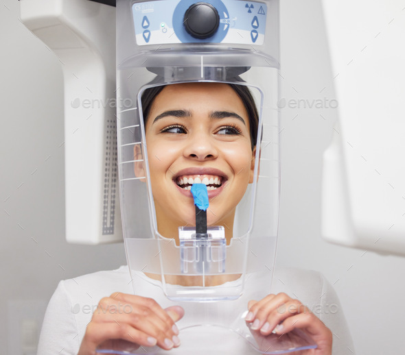 How perfect do my teeth look. Shot of a young woman using an x ray